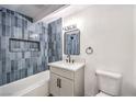 Well-lit bathroom showcasing blue vertical tiling and new fixtures at 701 N Yale St, Las Vegas, NV 89107