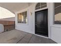 Inviting front porch with a dark wood door, white trim, and a large window offering lots of light at 7505 Crystal Clear Ave, Las Vegas, NV 89113