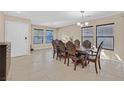 Elegant dining area with large windows and a stylish dining set, ideal for entertaining at 8112 Mustang Hill Ct, Las Vegas, NV 89131