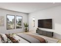 Bright bedroom featuring large windows, a TV, and a serene aesthetic with neutral tones at 8825-4 S Monte Cristo Way, Las Vegas, NV 89113