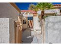 Inviting front entrance featuring a secure courtyard, decorative gate, and well-lit walkway at 8916 Evening Star Dr, Las Vegas, NV 89134