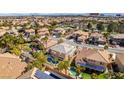 A high-angle view showcases the house, pool and the surrounding neighborhood and community at 941 Armandito Dr, Las Vegas, NV 89138