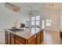 Spacious open kitchen features a large island with cooktop, and modern lighting at 941 Armandito Dr, Las Vegas, NV 89138