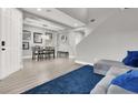 Open-concept living room with a comfortable couch and blue accent rug at 1016 Tropic Wind Ave, North Las Vegas, NV 89081
