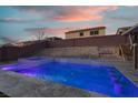 A luxurious pool featuring color lighting, a jacuzzi, and tranquil water features at 1016 Tropic Wind Ave, North Las Vegas, NV 89081