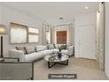 Staged living room featuring a neutral palette, plush seating, and contemporary decor at 11103 African Sunset St, Henderson, NV 89052