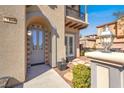 Close-up of the home's welcoming entryway featuring a stylish front door and decorative lighting at 11354 Merado Peak Dr, Las Vegas, NV 89135