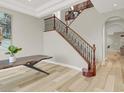 Elegant staircase with wood and iron railings complemented by modern flooring and a spacious layout at 11354 Merado Peak Dr, Las Vegas, NV 89135