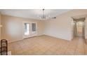 Spacious living room with tile flooring, sliding glass doors, and access to bathroom at 1813 Pluto Dr, Las Vegas, NV 89108