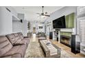 Open-concept living room with a fireplace and tile flooring at 1842 Trigger Way, North Las Vegas, NV 89032