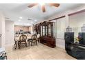 Open dining area with tile flooring, windows for natural light, and an elegant cabinet at 1930 Silver Crest Ct, North Las Vegas, NV 89031