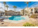 Community pool with lounge chairs and clear blue water, surrounded by well-maintained landscaping at 2110 Los Feliz St # 2037, Las Vegas, NV 89156