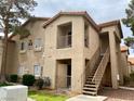 Two-story condo building featuring a private balcony, desert landscaping, and easy access to units at 2110 Los Feliz St # 2037, Las Vegas, NV 89156