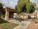 Shaded picnic area with a table and grill next to the well-maintained community space at 2110 Los Feliz St # 2037, Las Vegas, NV 89156