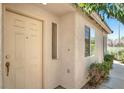 Home featuring a front door with sidelight window and neutral-toned stucco exterior at 2137 Hidden Ranch Ter, Henderson, NV 89052