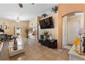 Spacious living room featuring tile flooring, neutral paint, and large windows that bring in natural light at 2137 Hidden Ranch Ter, Henderson, NV 89052