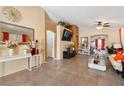 Bright, airy living room boasts tile flooring, large windows, and open layout perfect for entertaining at 2137 Hidden Ranch Ter, Henderson, NV 89052