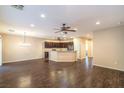 Spacious open-concept living room with hardwood floors and view into the kitchen area at 2475 Hamonah Dr, Henderson, NV 89044