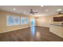 Open-concept living room featuring hardwood floors, recessed lighting, and sliding glass doors to the backyard at 2475 Hamonah Dr, Henderson, NV 89044