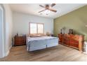 Comfortable bedroom includes wood floors, a ceiling fan, and neutral paint scheme at 2681 Benton Cove St, Laughlin, NV 89029