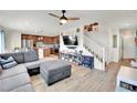 Open-concept living space with modern furnishings, hardwood floors, and an adjacent kitchen at 310 Rain Quail Way, Henderson, NV 89012