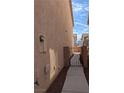 Side exterior view of a home with a walkway and gate leading to the backyard at 3681 Hidden Beach Ct, Las Vegas, NV 89115