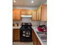 A kitchen featuring wooden cabinets and a black gas range at 3681 Hidden Beach Ct, Las Vegas, NV 89115