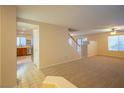 Open-concept living room, tile floors, staircase to the upper level, and access to the kitchen at 3725 Shanagolden St, Las Vegas, NV 89129