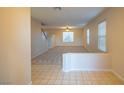 Bright living room with multiple windows, neutral carpet, tile entry and staircase at 3725 Shanagolden St, Las Vegas, NV 89129