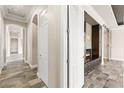 Hallway with multiple doors, archways, and a stone floor at 3914 Jacob Lake Cir, Las Vegas, NV 89118