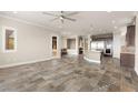 Open living room with stone floors, a ceiling fan, and a seating nook at 3914 Jacob Lake Cir, Las Vegas, NV 89118