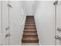 A carpeted stairway leads to the upper levels of the home, with a white wall at 4305 Morgan Manor St # 3, North Las Vegas, NV 89032