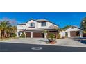 Charming two-story home with a three-car garage, lush landscaping, and a concrete driveway at 4880 Hayride St, Las Vegas, NV 89149