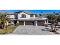 Inviting two-story home with a three-car garage, tile roof, solar panels, and concrete driveway at 4880 Hayride St, Las Vegas, NV 89149