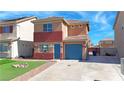Two-story home featuring colorful front exterior with well-kept lawn at 5288 Emelita St, Las Vegas, NV 89122