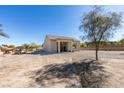 Tan single story home with desert landscaping and covered front porch at 6094 S Lamb Blvd, Las Vegas, NV 89120