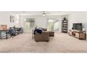 Spacious living room with neutral carpeting, plenty of natural light, and an open floor plan at 617 Abrazar Ave, North Las Vegas, NV 89081