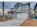 This two-story home features a 2-car garage, desert landscaping, and a covered porch at 6254 Peach Orchard Rd, Las Vegas, NV 89142