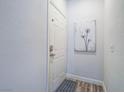 Inviting entryway with neutral paint, wood-look flooring, and decorative art at 7111 S Durango Dr # 305, Las Vegas, NV 89113
