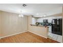 Eat-in kitchen area featuring a breakfast bar and black appliances at 8452 Boseck Dr # 110, Las Vegas, NV 89145