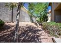 Exterior shot showing trees, bushes and block wall at 8501 W University Ave # 2020, Las Vegas, NV 89147