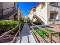 Exterior walkway with well-manicured landscaping and railings at 8501 W University Ave # 2020, Las Vegas, NV 89147
