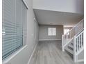 Bright, open-concept living room with gray walls, tile flooring, and lots of natural light at 9239 Albus Hills Ave, Las Vegas, NV 89143