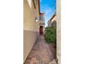 Paver pathway leading to the front door with desert landscaping at 10556 Nantucket Ridge Ave, Las Vegas, NV 89166