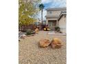 View of the front yard with desert landscaping, rocks, and holiday decorations at 1071 Nordyke Ave, Henderson, NV 89015