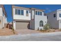 Charming two-story home featuring a two car garage, neutral stucco, and mature landscaping at 1320 Crimson Sunbird Ave, North Las Vegas, NV 89084