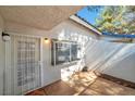 Private courtyard with a security door and a charming window at 2110 Bavington Dr # C, Las Vegas, NV 89108