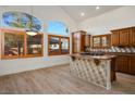 Bright eat-in kitchen featuring a center island with gas cooktop and warm wood cabinetry at 2204 Ambermill Ct, Henderson, NV 89052