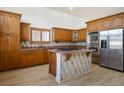 Well-appointed kitchen with stainless steel appliances, a center island and warm wood cabinets at 2204 Ambermill Ct, Henderson, NV 89052