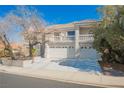 Charming two-story home with tile roof, three-car garage, and desert landscaping at 2493 Ram Crossing Way, Henderson, NV 89074